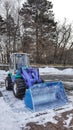 Backhoe to excavate the snow in ground